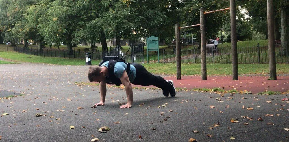 Performing push-ups while wearing the Gravity Fitness Weighted Vest