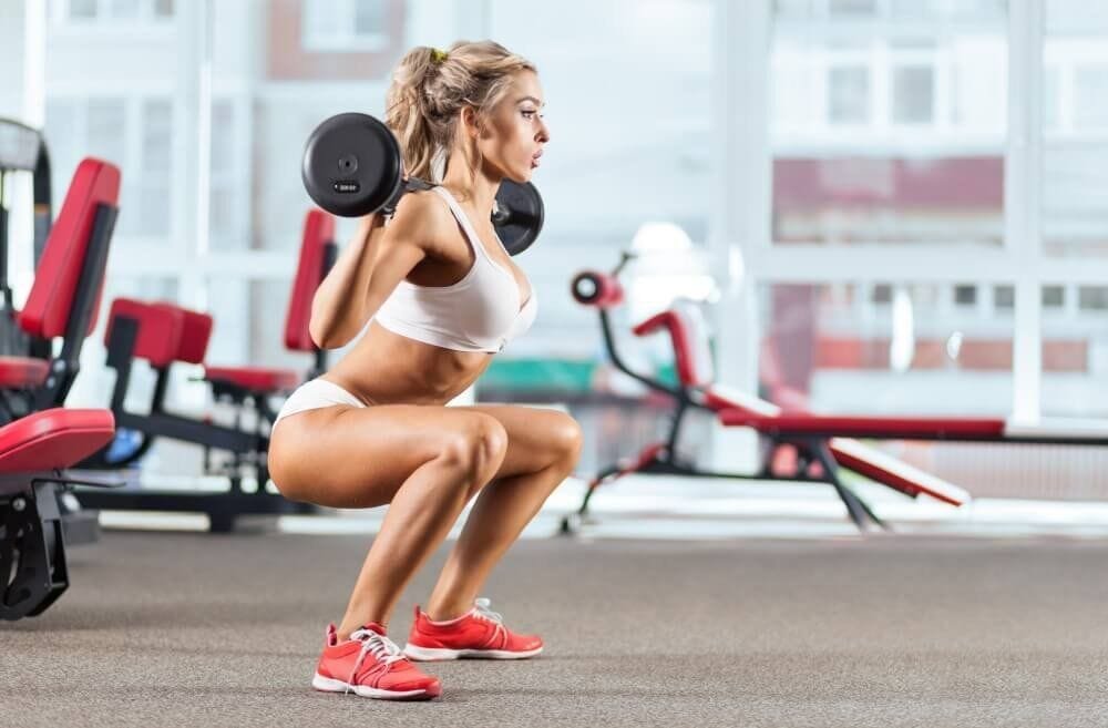 Woman performing barbell squat