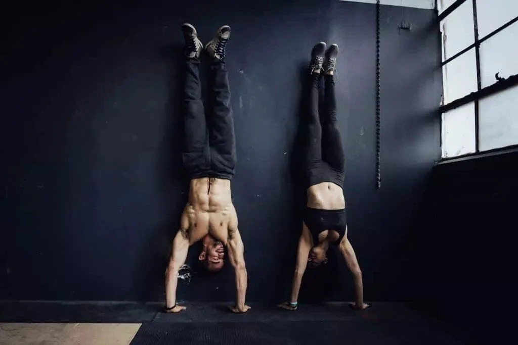 The White Coat Trainer - Couple performing a handstand together