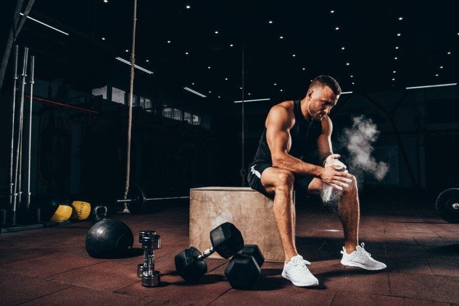 Man resting on a box in the gym