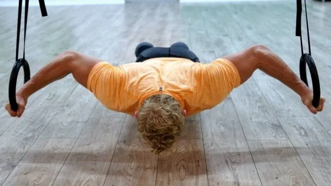 Bodyweight Ring Fly exercise using gymnastic rings by Vahva Fitness