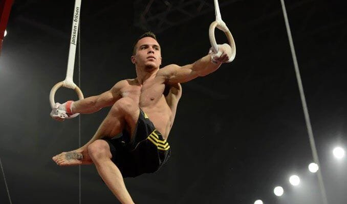Man performing Iron Cross on the gymnastic rings