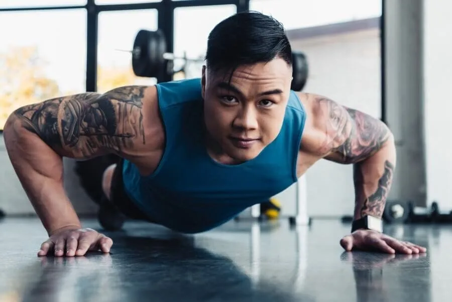 Man performing wide grip plank exercise