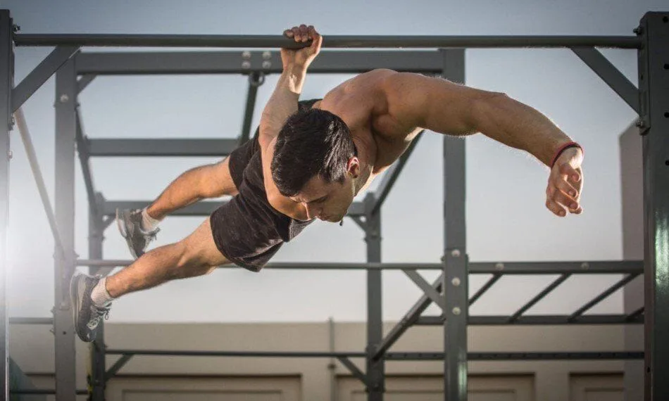 Man performing a one-arm back lever