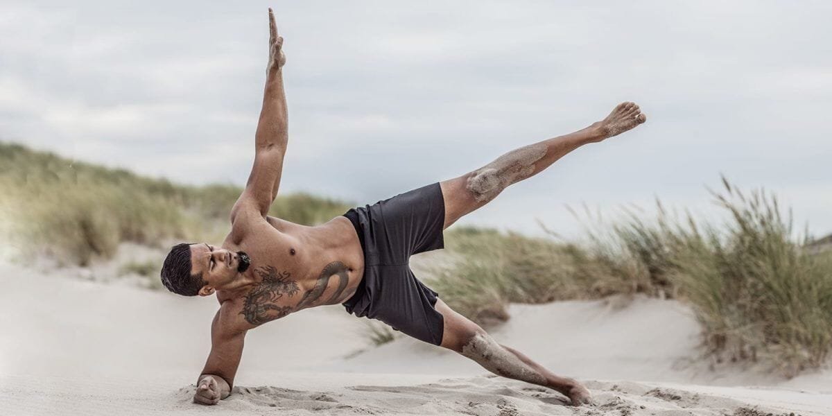 Man performing Yoga on the beach