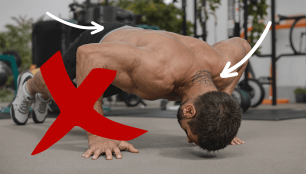 Man demonstrating incorrect pushup form with red X mark and arrows pointing to improper head position and hand placement, showing common calisthenics technique errors